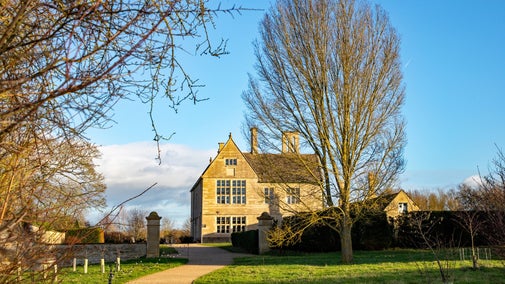 An accessible path leading up to the Manor House, with a string of lights highlighting the way.